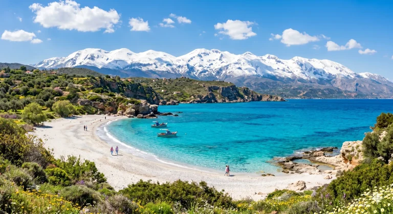 Plaja cu apa turcoaz si munti Albi cu zapada in fundal, peisaj superb din Creta in luna aprilie